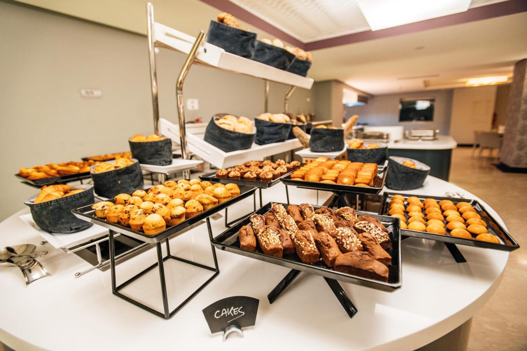 Grand Mogador City Center Casablanca Exterior photo A selection of cakes at a buffet